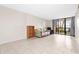 Bright living room with tile floors, comfortable seating, and sliding glass doors to balcony at 3006 Caring Way # 210, Port Charlotte, FL 33952