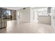 Open living space with tiled floors and access to a balcony, perfect for relaxation at 3006 Caring Way # 210, Port Charlotte, FL 33952