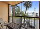 Cozy patio area with palm trees, seating, and views of the parking area at 3006 Caring Way # 210, Port Charlotte, FL 33952