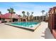 The community pool provides a relaxing setting with mature palms and building views at 3006 Caring Way # 210, Port Charlotte, FL 33952