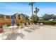 Community pool area featuring chairs, umbrellas and beautiful landscaping at 3006 Caring Way # 210, Port Charlotte, FL 33952