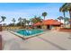 Community pool surrounded by lush landscaping at 3006 Caring Way # 210, Port Charlotte, FL 33952