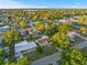 An aerial view displays the cozy neighborhood, featuring well-maintained homes surrounded by lush greenery and clear blue skies at 3169 Bellevue St, Sarasota, FL 34237