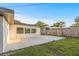 Spacious backyard featuring a concrete patio, green grass, and a well-maintained privacy fence at 3169 Bellevue St, Sarasota, FL 34237