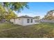 Large backyard featuring new white paint on home, concrete patio, and green grass at 3169 Bellevue St, Sarasota, FL 34237