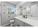 Bathroom with a modern vanity, bright lighting, an updated shower, and a large mirror, creating a serene space at 3169 Bellevue St, Sarasota, FL 34237