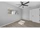 Bright bedroom featuring wood look floors, a ceiling fan, and a closet, providing storage and style at 3169 Bellevue St, Sarasota, FL 34237