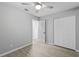 Light-filled bedroom featuring wood-look tile, a ceiling fan, and closet at 3169 Bellevue St, Sarasota, FL 34237