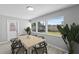 Comfortable dining room with a wooden table, stylish chairs, and large windows overlooking the backyard at 3169 Bellevue St, Sarasota, FL 34237