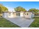 Charming single-story home featuring a freshly painted exterior with a spacious concrete patio area at 3169 Bellevue St, Sarasota, FL 34237