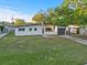 Freshly painted home with green grass, a modern-style exterior, and a single-car garage at 3169 Bellevue St, Sarasota, FL 34237
