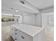 Bright kitchen featuring an island with a white countertop and ample natural light from large windows at 3169 Bellevue St, Sarasota, FL 34237
