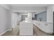 A modern, open-concept kitchen with an island, stainless steel appliances, and white cabinetry at 3169 Bellevue St, Sarasota, FL 34237
