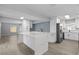 A modern, open-concept kitchen with an island, stainless steel appliances, and white cabinetry at 3169 Bellevue St, Sarasota, FL 34237