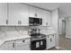 Modern kitchen featuring stainless steel appliances and stylish white countertops with backsplash at 3169 Bellevue St, Sarasota, FL 34237