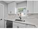 Bright kitchen showcasing a modern sink and white countertop with sleek cabinets at 3169 Bellevue St, Sarasota, FL 34237