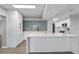 Bright, modern kitchen with white cabinetry, a central island, and a stylish blue tile backsplash at 3169 Bellevue St, Sarasota, FL 34237