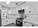 Modern kitchen boasts stainless steel appliances, white cabinets, and stylish white countertops with backsplash at 3169 Bellevue St, Sarasota, FL 34237