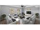 Inviting living room with cozy seating, large windows, and a modern ceiling fan for year-round comfort at 3169 Bellevue St, Sarasota, FL 34237