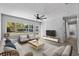A bright living room with large windows, neutral furniture, tile floors, and an open, airy feel at 3169 Bellevue St, Sarasota, FL 34237