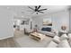A stylish living room featuring neutral tones, a ceiling fan, and an open layout flowing into the kitchen at 3169 Bellevue St, Sarasota, FL 34237