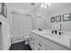 Modern bathroom with double sinks, sleek black hardware, and a stylish shower curtain adds a modern touch at 3508 Anchor Bay Trl, Lakewood Ranch, FL 34211