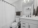 Clean bathroom features a shower with curtain, modern vanity, and coordinating black fixtures for a contemporary feel at 3508 Anchor Bay Trl, Lakewood Ranch, FL 34211