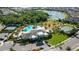 Aerial view of neighborhood community pool, tennis courts, and playground by a lake at 3508 Anchor Bay Trl, Lakewood Ranch, FL 34211