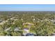 Expansive aerial view of a neighborhood surrounded by lush greenery and blue skies at 3694 Crittendon St, North Port, FL 34286