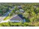 An aerial view shows the house nestled among lush greenery and well-maintained lawns at 3694 Crittendon St, North Port, FL 34286