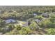 Aerial view of a home surrounded by lush trees and well-maintained lawns at 3694 Crittendon St, North Port, FL 34286