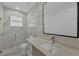 Bright bathroom featuring a modern sink, sleek mirror, and elegant marble tiling in shower at 3694 Crittendon St, North Port, FL 34286