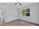 Well-lit bedroom features a ceiling fan, double closet, and a large window with outdoor views at 3694 Crittendon St, North Port, FL 34286
