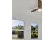 Bedroom featuring an outdoor view from two large windows and a ceiling fan at 3694 Crittendon St, North Port, FL 34286
