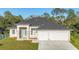 Beautiful single-story home featuring a two-car garage and well-manicured lawn at 3694 Crittendon St, North Port, FL 34286