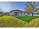 Exterior view of the home with a covered patio and landscaped yard at 3694 Crittendon St, North Port, FL 34286