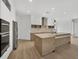 Modern kitchen features an island, stainless steel appliances, and light countertops at 3694 Crittendon St, North Port, FL 34286