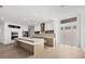 Modern kitchen with an island, white cabinets, stainless steel appliances, and wood flooring at 3694 Crittendon St, North Port, FL 34286
