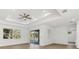 Bright living room with wood floors, tray ceilings, and sliding glass doors at 3694 Crittendon St, North Port, FL 34286