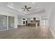 Bright living room features an open floorplan, ceiling fan, and modern flooring at 3694 Crittendon St, North Port, FL 34286