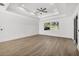 Bright living room with wood floors, tray ceilings, and a large window at 3694 Crittendon St, North Port, FL 34286