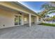 Spacious covered patio with tiled floors and stone-accented columns offers outdoor living at 3694 Crittendon St, North Port, FL 34286