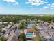 Aerial view of community featuring a swimming pool, clubhouse, and lush surroundings at 3718 59Th Ave W # 3718, Bradenton, FL 34210