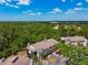 Aerial view of community buildings surrounded by lush greenery and ample parking at 3718 59Th Ave W # 3718, Bradenton, FL 34210