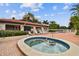 Hot tub surrounded by palm trees, lounge chairs, and clear skies at 3718 59Th Ave W # 3718, Bradenton, FL 34210