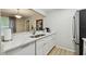 Updated kitchen featuring quartz countertops, stainless steel refrigerator, and stainless steel sink at 3718 59Th Ave W # 3718, Bradenton, FL 34210