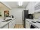Bright kitchen featuring white cabinets, stainless steel refrigerator and light wood flooring at 3718 59Th Ave W # 3718, Bradenton, FL 34210
