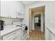 Kitchen with white cabinets, quartz countertops and white appliances at 3718 59Th Ave W # 3718, Bradenton, FL 34210
