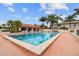 Community pool surrounded by palm trees, lounge chairs, and clear skies at 3718 59Th Ave W # 3718, Bradenton, FL 34210