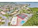 Aerial view of a waterfront community featuring tennis courts, a pool, boat docks, and vibrant landscaping at 3859 Catalina Dr, Bradenton, FL 34210